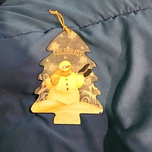 Vintage metal Ornament with a snowman winter scene and the word Celebrate